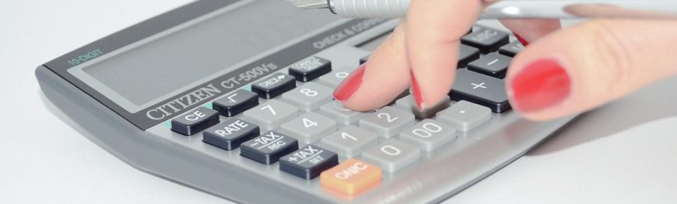 Hand using a calculator at cma accountancy