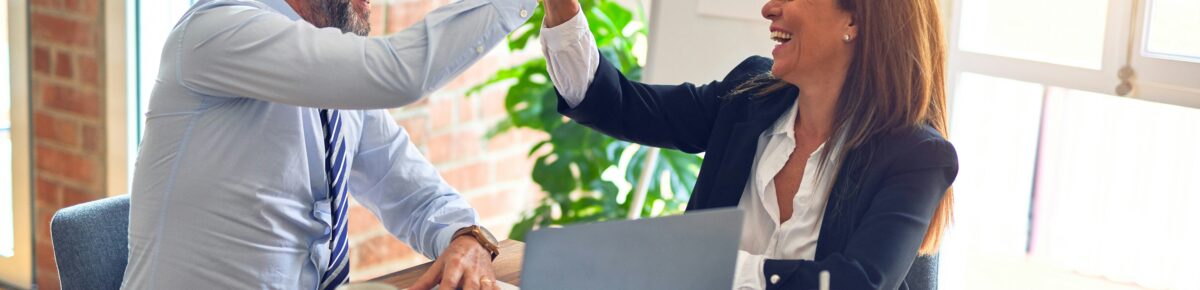 Two people celebrating a business success