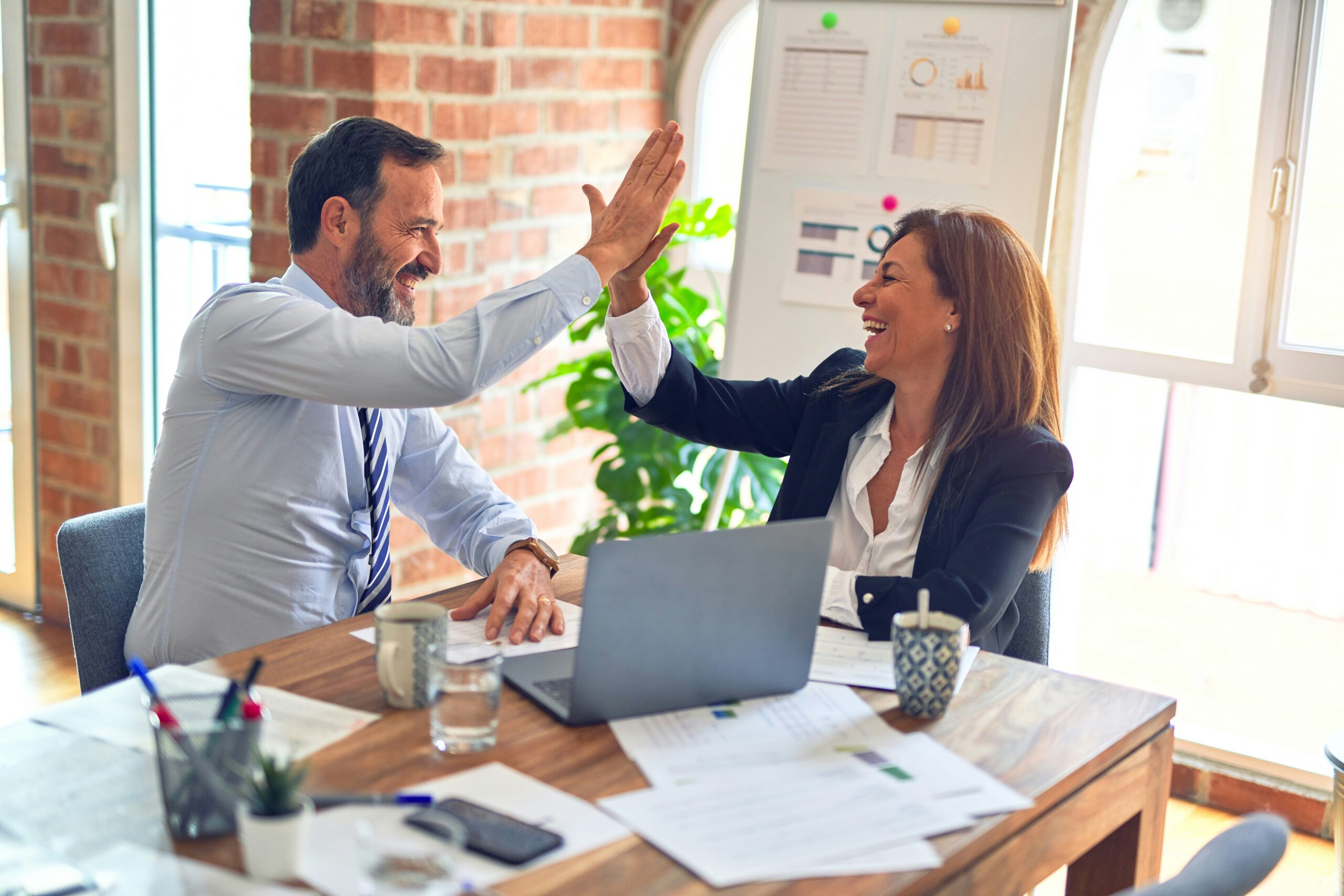 Two people celebrating a business success
