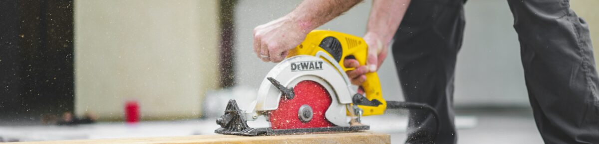 Construction worker cutting timber