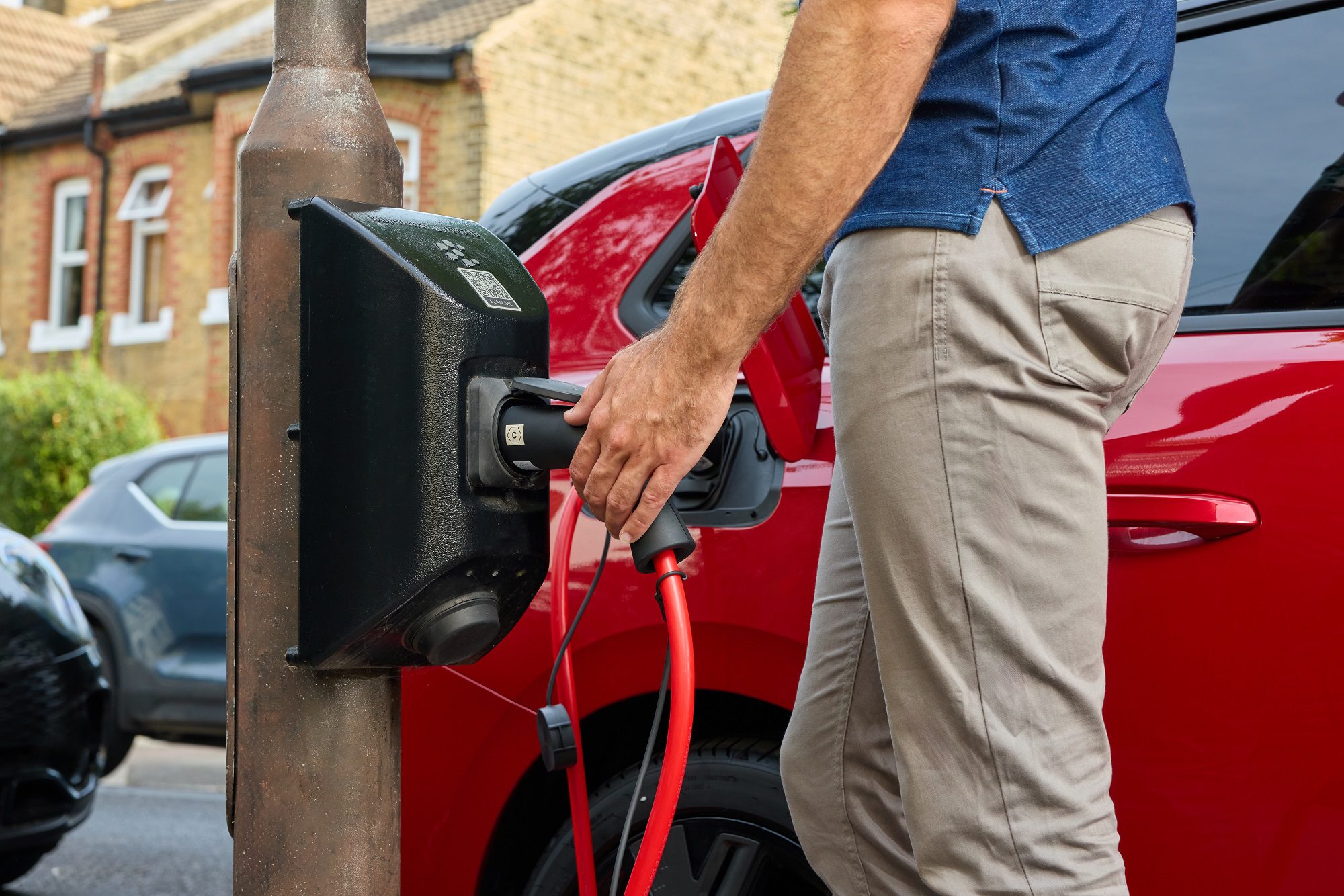 Plugging an electric car into a charging point