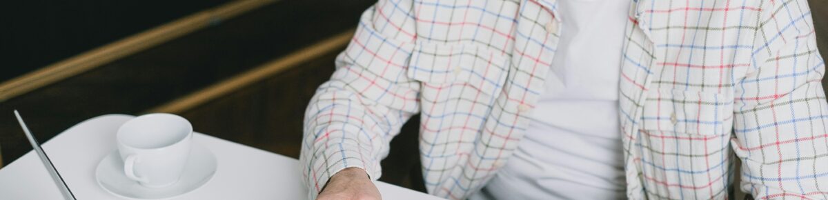 Pensioner looking at forms and working on a computor